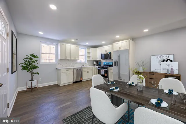 a living room with kitchen island furniture and a potted plant