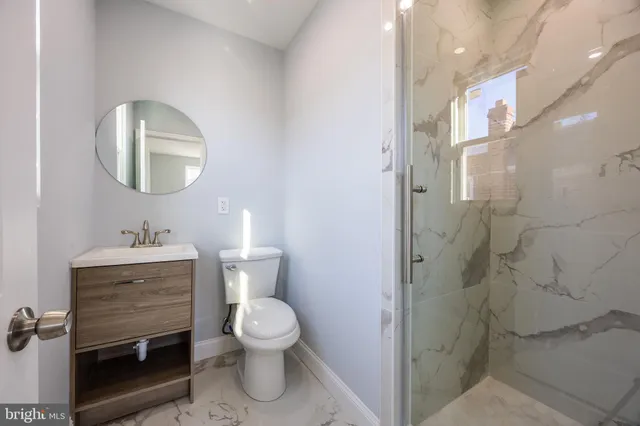 a bathroom with a toilet sink and a mirror