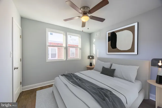 a bedroom with a bed and a painting on the wall