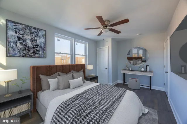 a bedroom with a large bed and a chandelier