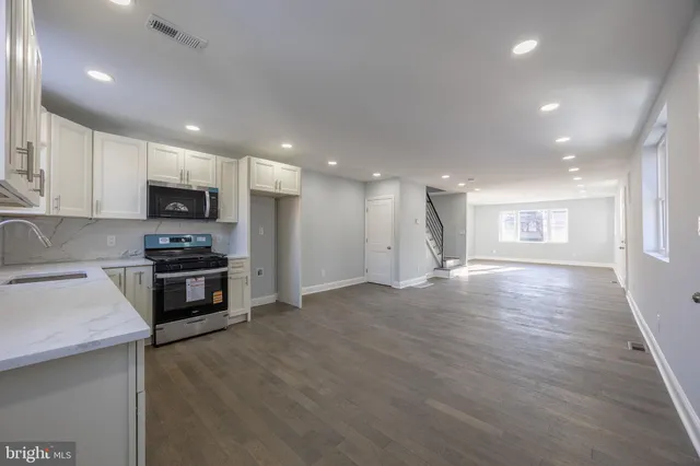 a kitchen with granite countertop a stove and a refrigerator