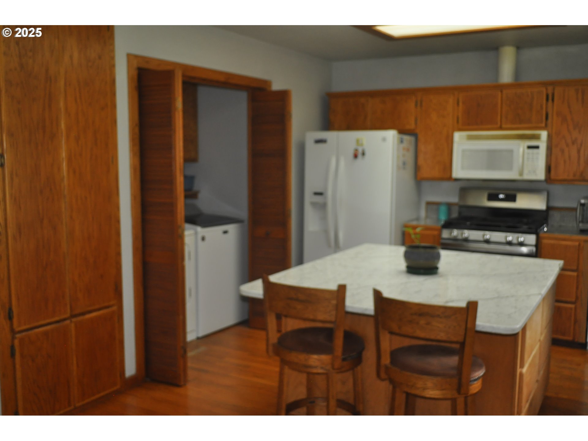 4215 Mt Reuben Road Glendale, OR 97442 - Photo 8 of 40 a kitchen with stainless steel appliances granite countertop a refrigerator a sink dishwasher with a dining table and chair