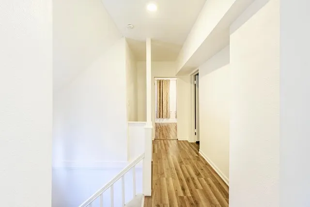 a view of hallway with wooden floor