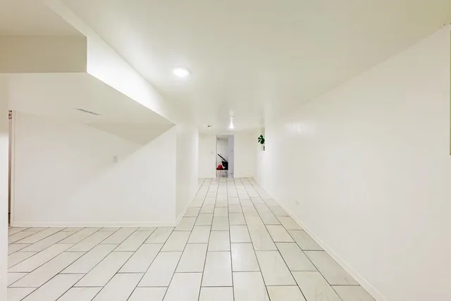 a view of an empty room and a window