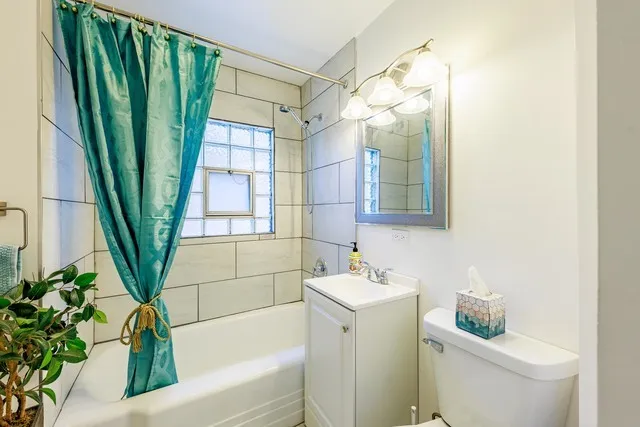 a bathroom with a sink a mirror a toilet and a shower