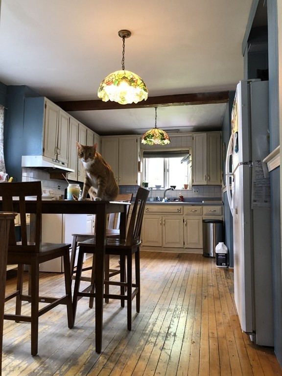 603 Temple Street Whitman, MA 02382 - Photo 4 of 8 a view of a dining room with furniture wooden floor and chandelier