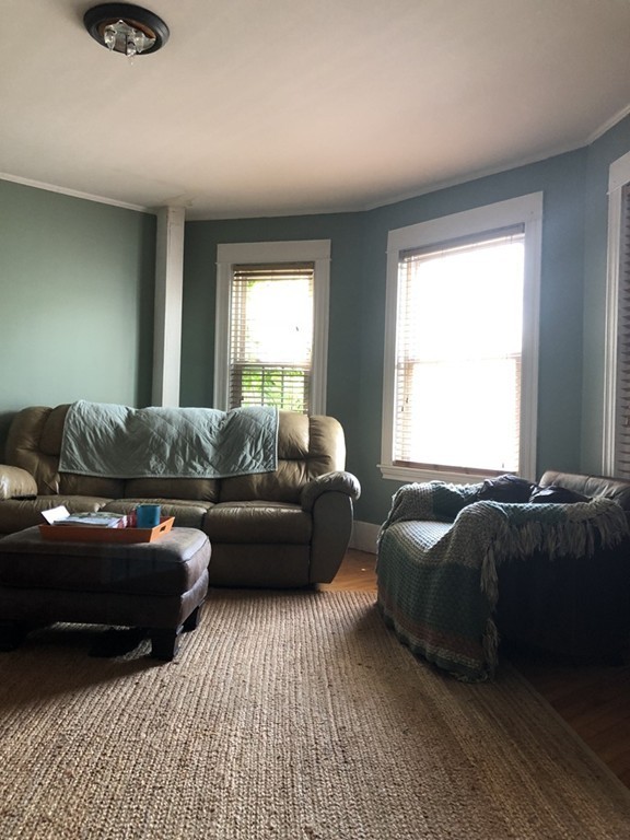 603 Temple Street Whitman, MA 02382 - Photo 5 of 8 a living room with a couch and a window