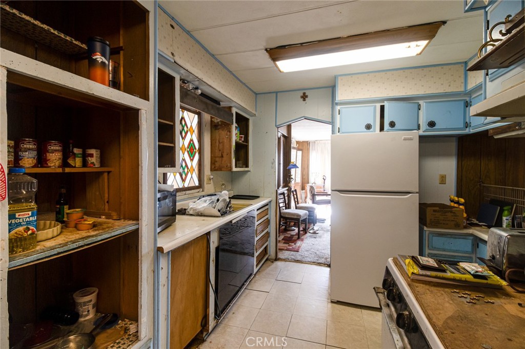 9443 Sharondale Road Calimesa, CA 92320 - Photo 11 of 22 a kitchen with a refrigerator and a stove