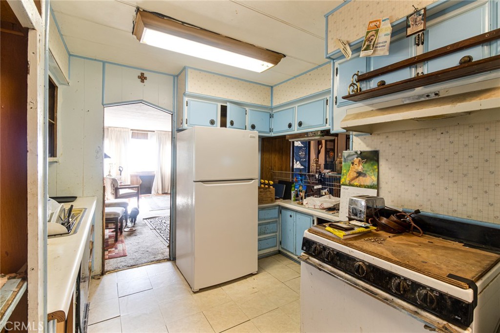 9443 Sharondale Road Calimesa, CA 92320 - Photo 12 of 22 a room with furniture a refrigerator and a table