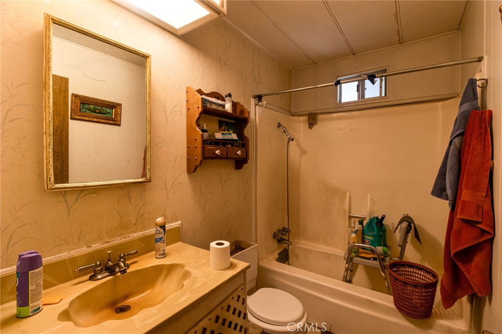 9443 Sharondale Road Calimesa, CA 92320 - Photo 14 of 22 a bathroom with a sink a toilet and shower