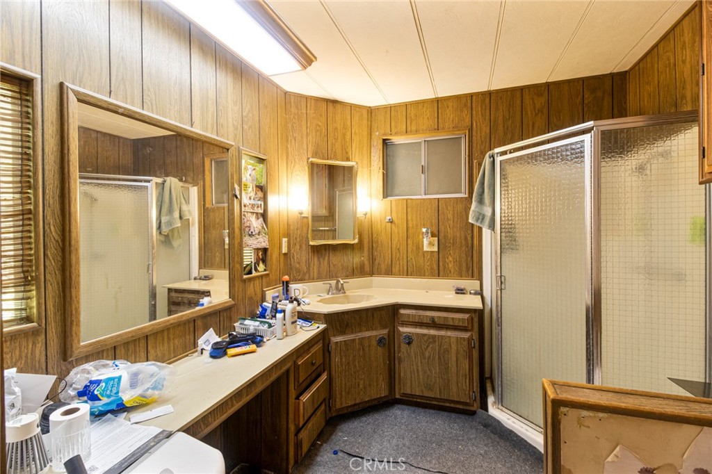 9443 Sharondale Road Calimesa, CA 92320 - Photo 18 of 22 a bathroom with a sink mirror and a shower
