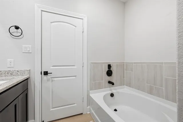 a bathroom with a bathtub and shower