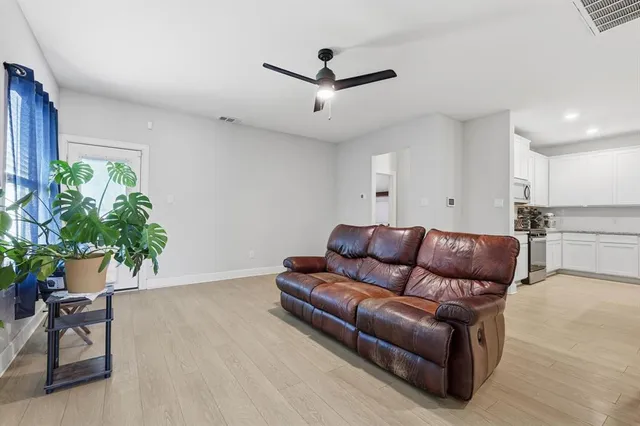 a living room with furniture and a potted plant