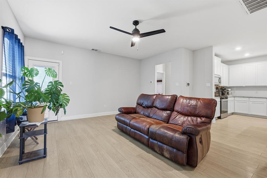 1334 Windemere Way Princeton, TX 75407 - Photo 13 of 31 a living room with furniture and a potted plant