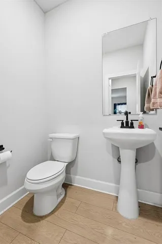 a bathroom with a sink toilet and a mirror