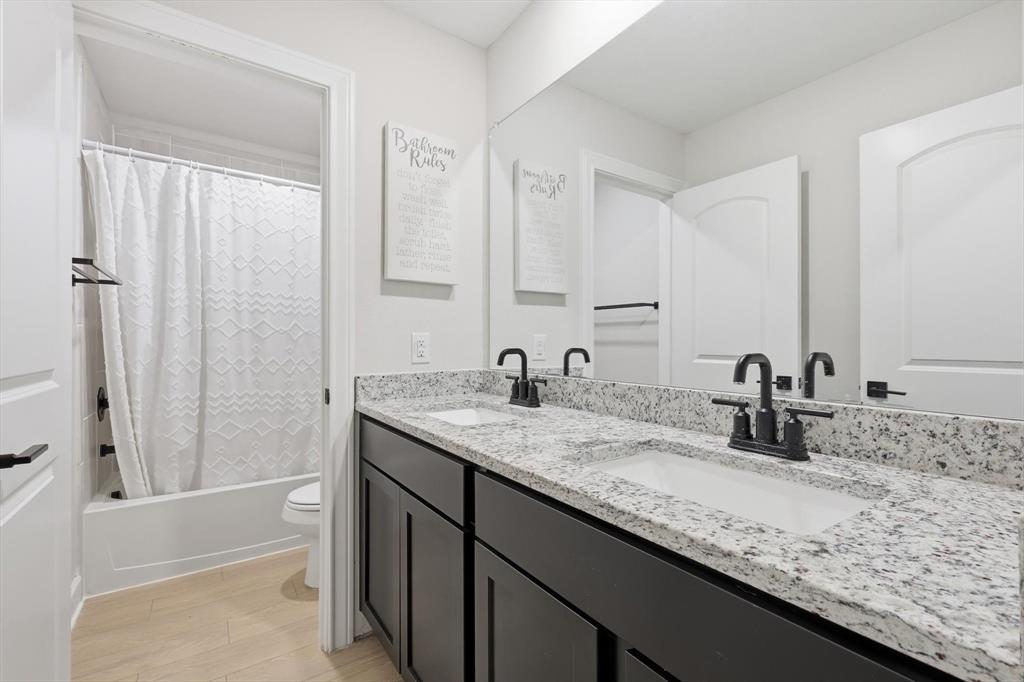 1334 Windemere Way Princeton, TX 75407 - Photo 19 of 31 a bathroom with a granite countertop sink and a mirror
