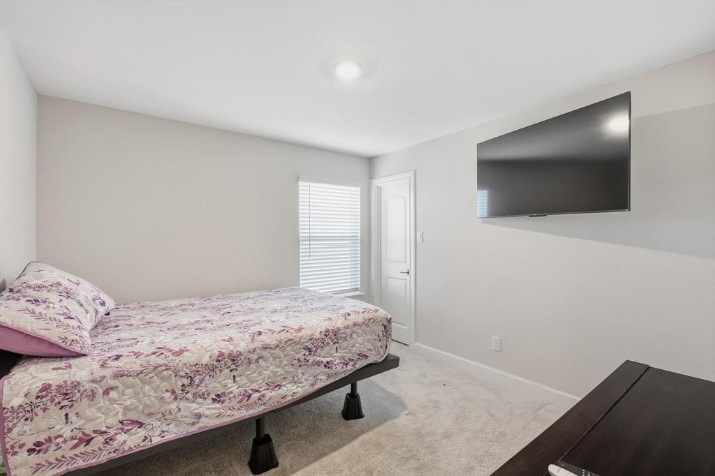 1334 Windemere Way Princeton, TX 75407 - Photo 20 of 31 a bedroom with a bed and a flat screen tv