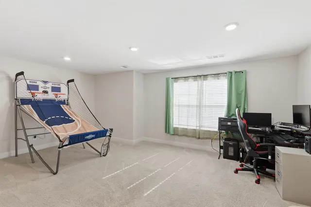 a view of a workspace with furniture and a window