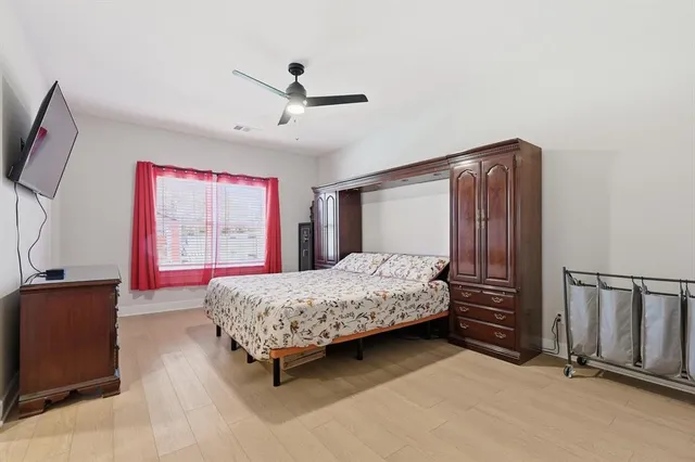 a bedroom with a large bed and a chandelier