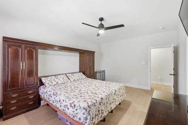 a bedroom with a large bed and a chandelier
