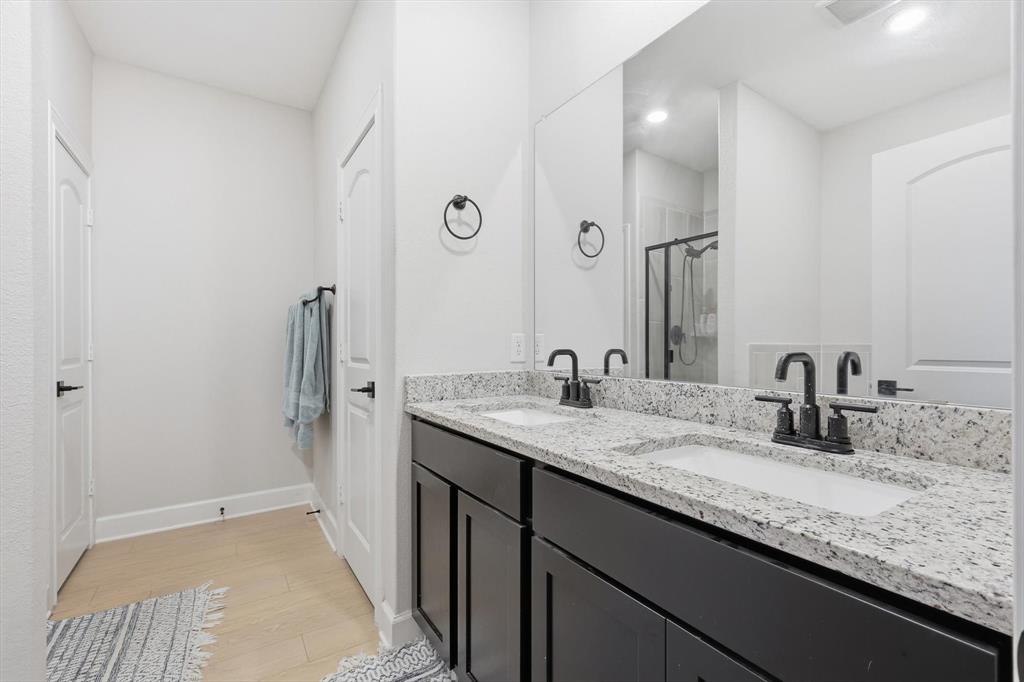 1334 Windemere Way Princeton, TX 75407 - Photo 10 of 31 a bathroom with a granite countertop sink and a mirror