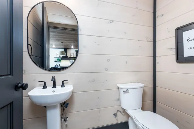 a bathroom with a toilet sink and mirror