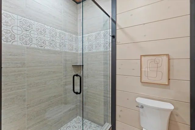a bathroom with a shower and toilet
