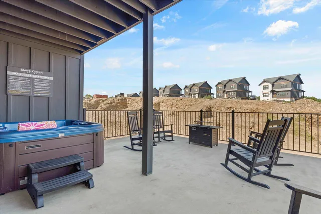 a roof deck with couch and chairs
