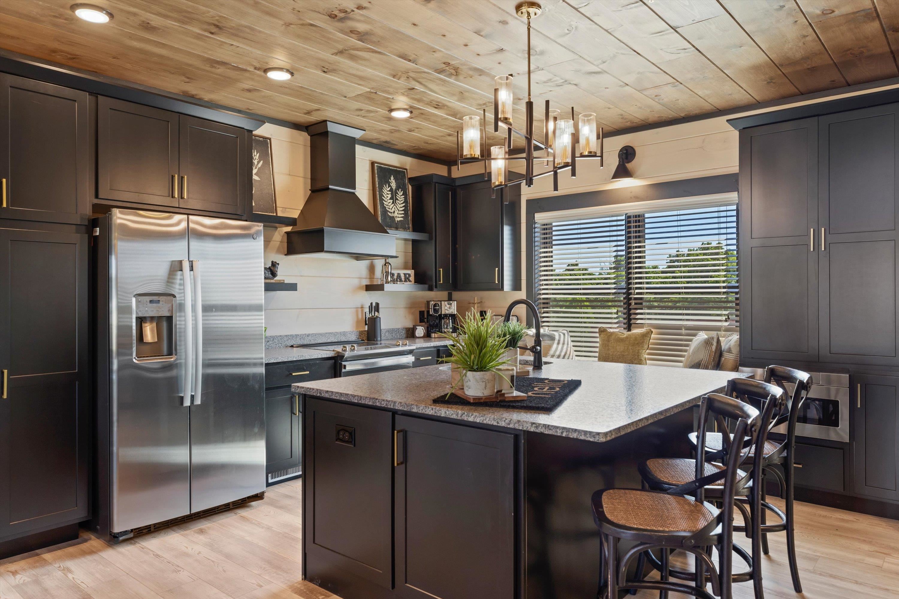 327 Rambling Crk Way, Unit LOT 54R Sevierville, TN 37863 - Photo 5 of 40 a kitchen with stainless steel appliances granite countertop a sink refrigerator and chairs