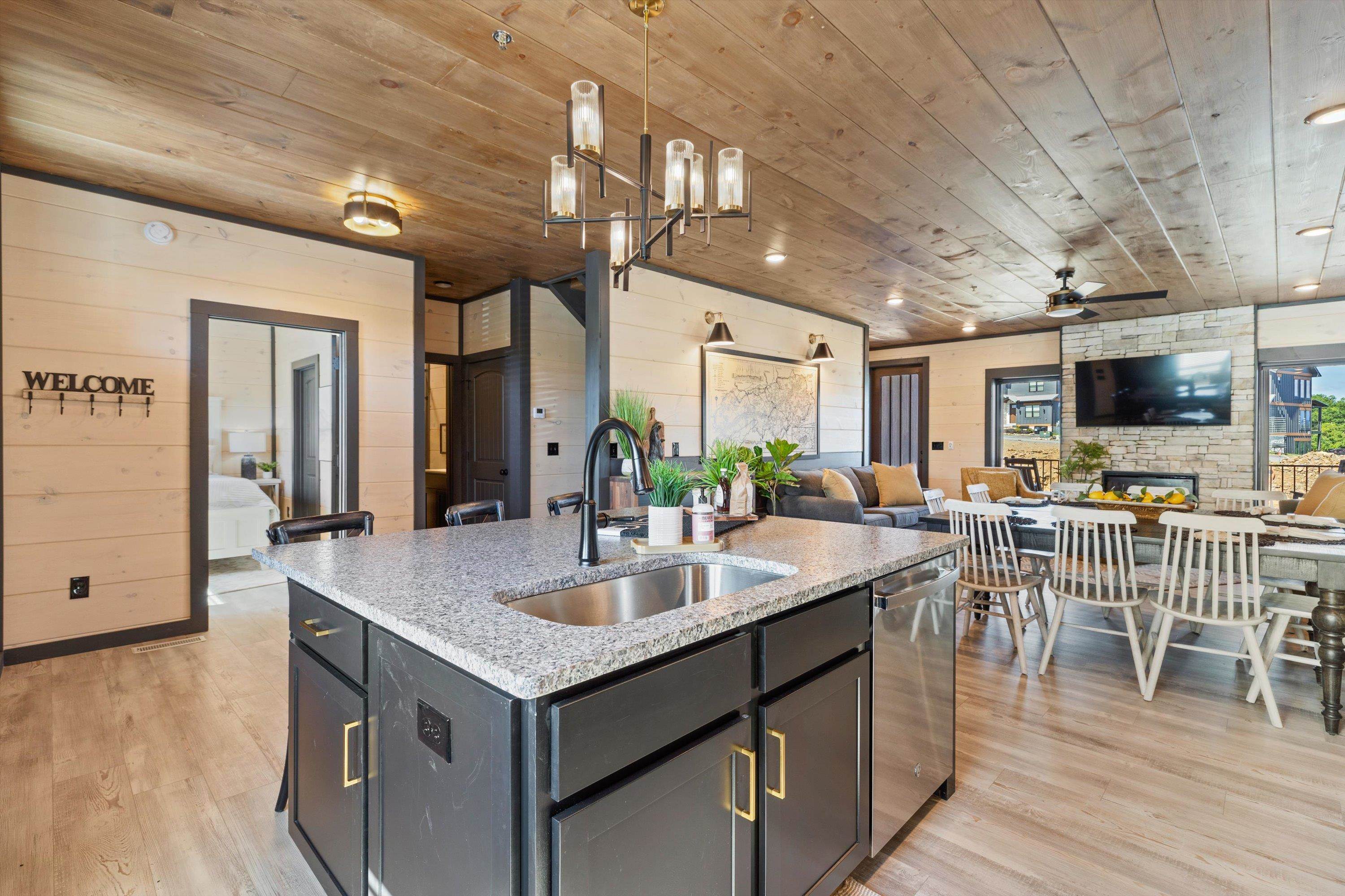 327 Rambling Crk Way, Unit LOT 54R Sevierville, TN 37863 - Photo 6 of 40 a open kitchen with stainless steel appliances granite countertop a lot of counter space and wooden floors