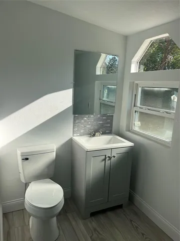 a bathroom with a toilet sink and mirror