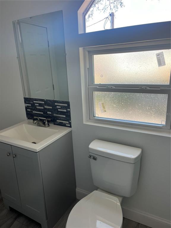 17300 Shady Hills Road Spring Hill, FL 34610 - Photo 17 of 17 a bathroom with a toilet a sink and a window