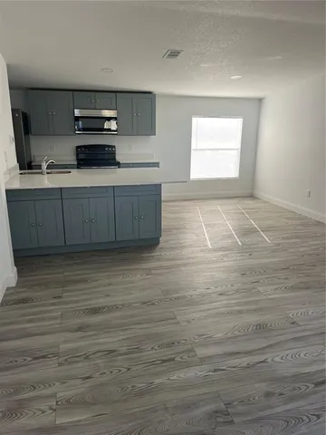 a kitchen with stainless steel appliances wooden cabinets and a sink