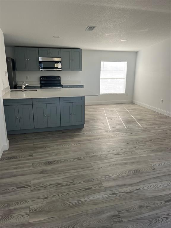17300 Shady Hills Road Spring Hill, FL 34610 - Photo 2 of 17 a kitchen with stainless steel appliances wooden cabinets and a sink