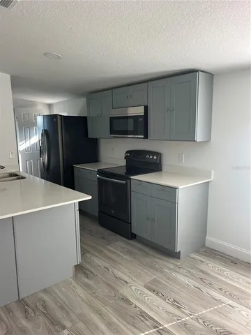 a kitchen with a cabinets and steel appliances