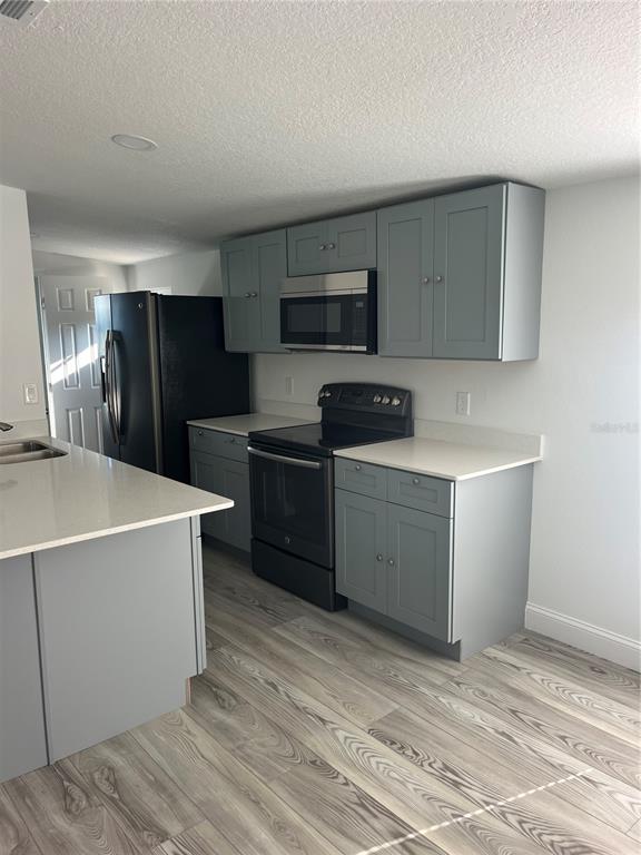 17300 Shady Hills Road Spring Hill, FL 34610 - Photo 6 of 17 a kitchen with a cabinets and steel appliances