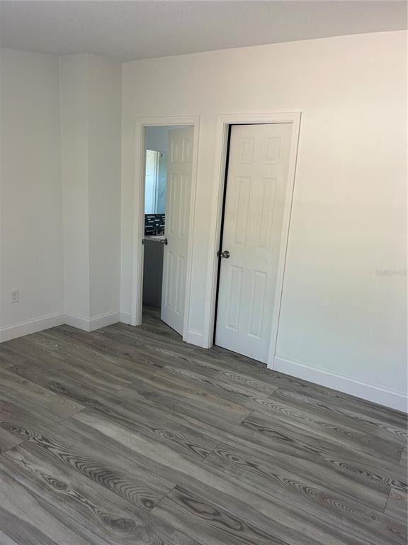 17300 Shady Hills Road Spring Hill, FL 34610 - Photo 10 of 17 a view of an empty room with wooden floor