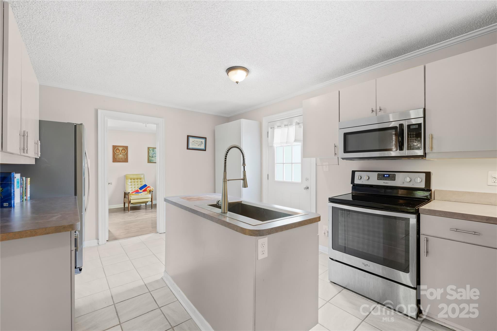 485 Lincoln Street Cramerton, NC 28032 - Photo 3 of 16 a kitchen with stainless steel appliances granite countertop a sink stove and refrigerator