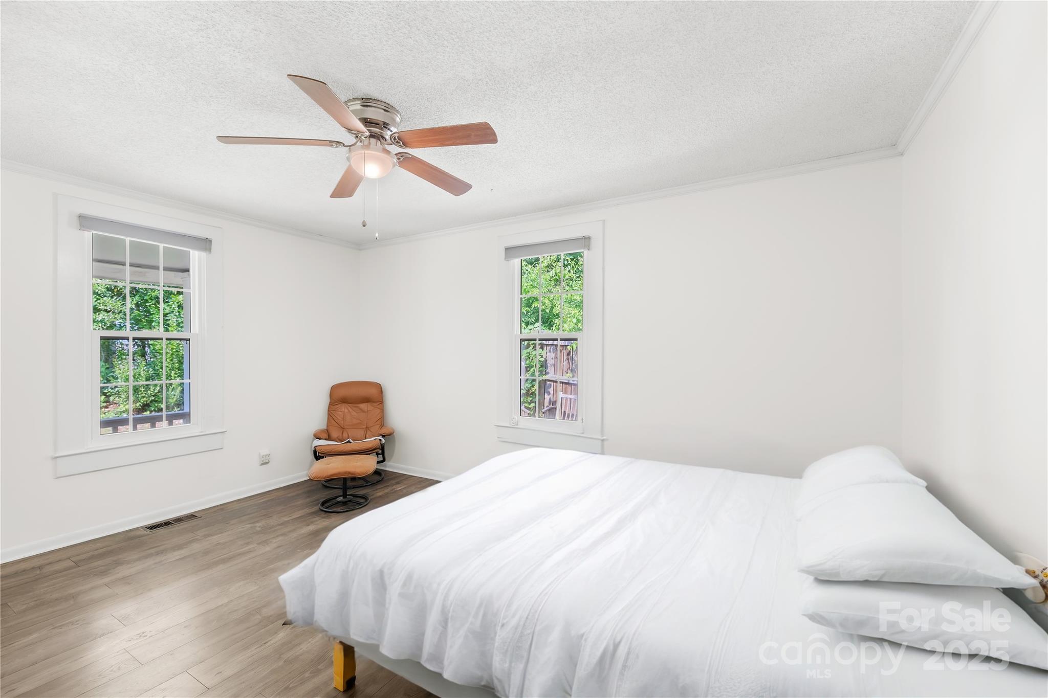 485 Lincoln Street Cramerton, NC 28032 - Photo 8 of 16 a bedroom with a bed and wooden floor