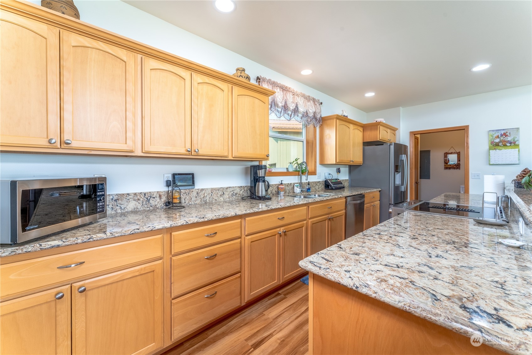 94 Shoemaker Road Manson, WA 98831 - Photo 11 of 37 a kitchen with stainless steel appliances granite countertop a sink and cabinets