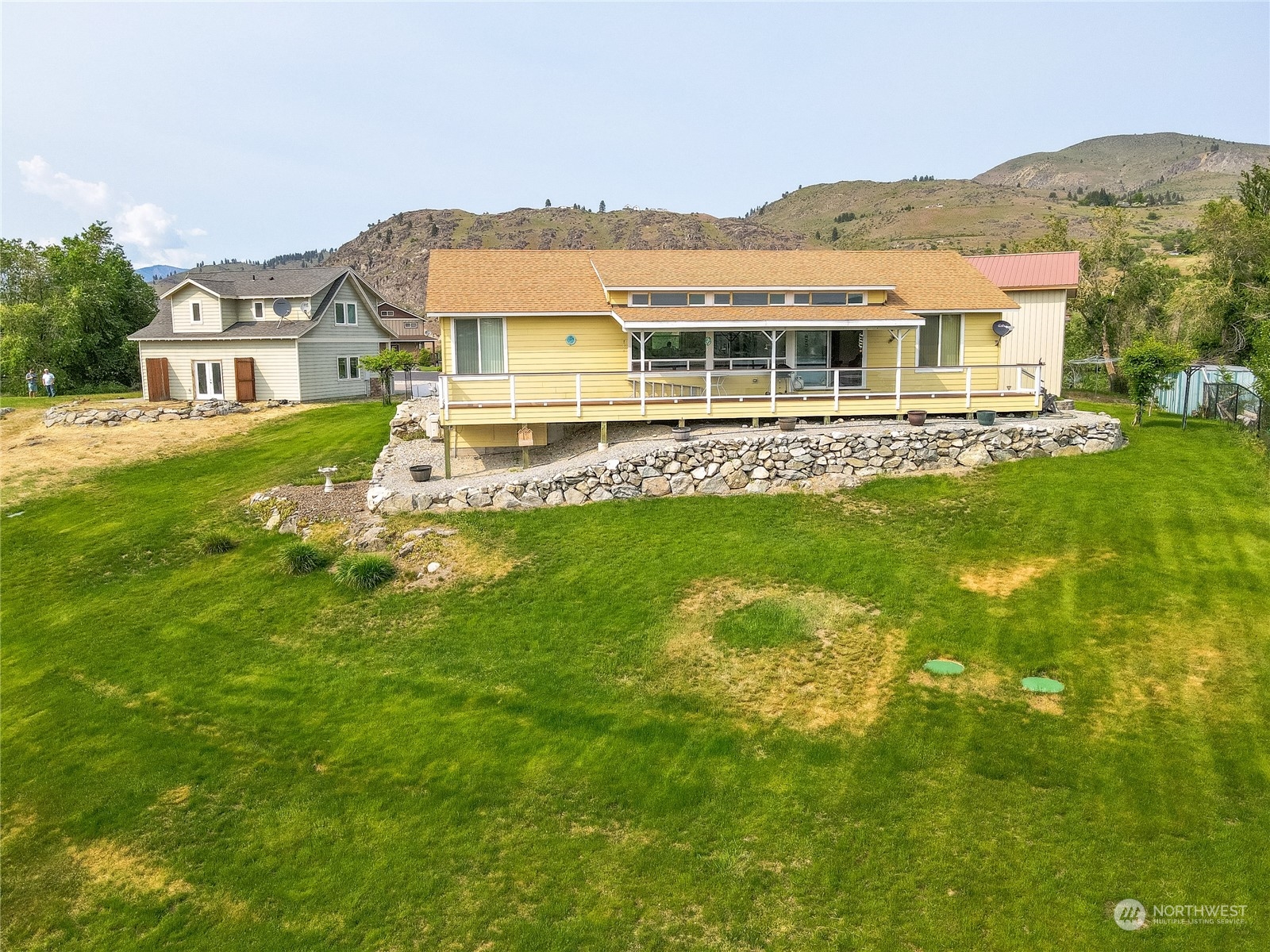 94 Shoemaker Road Manson, WA 98831 - Photo 18 of 37 a view of a house with a big yard