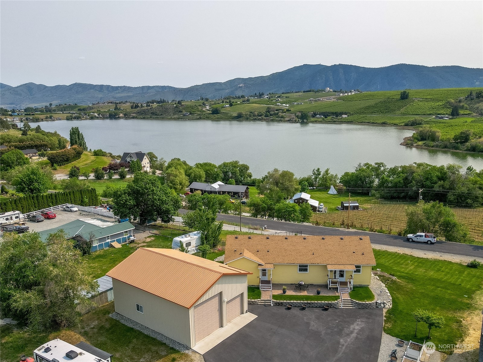 94 Shoemaker Road Manson, WA 98831 - Photo 2 of 37 a view of a lake with couches and city view