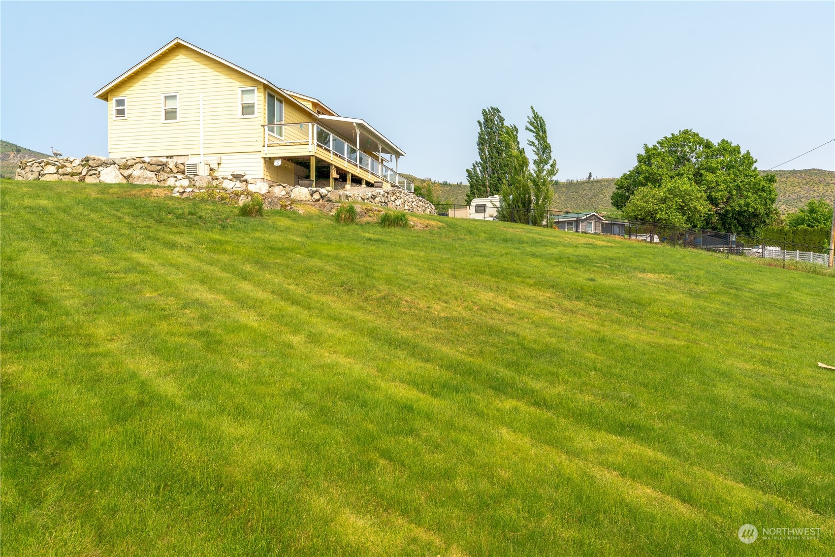 94 Shoemaker Road Manson, WA 98831 - Photo 23 of 37 a view of a house with a big yard