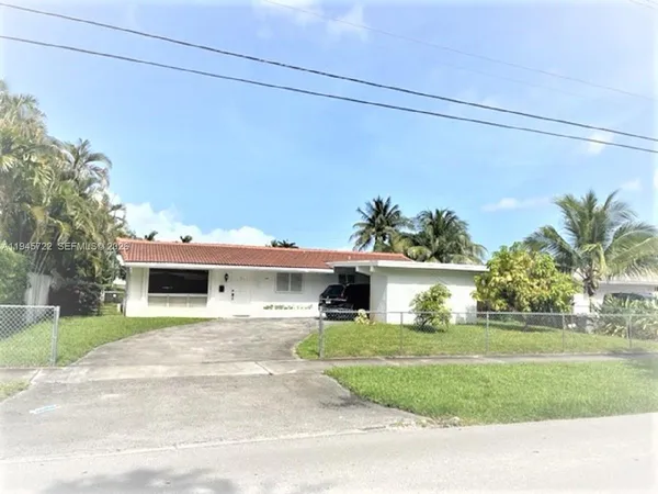 a front view of a house with a garden and yard