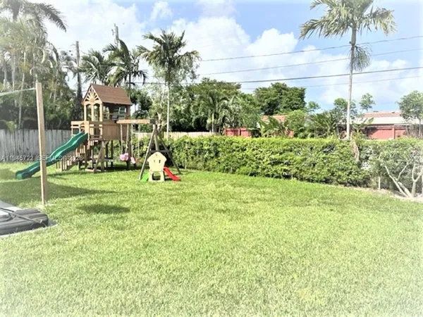 a ground with lots of green space and palm trees