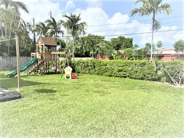 a ground with lots of green space and palm trees