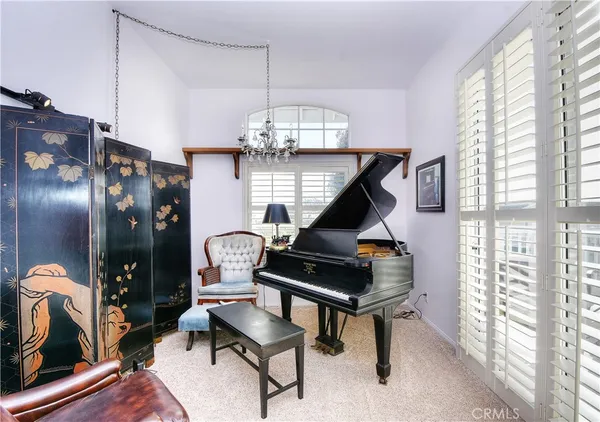 a living room with furniture and a chandelier