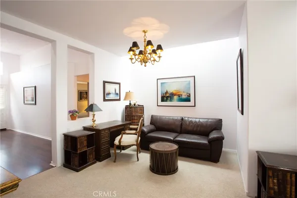 a living room with furniture a rug and a window