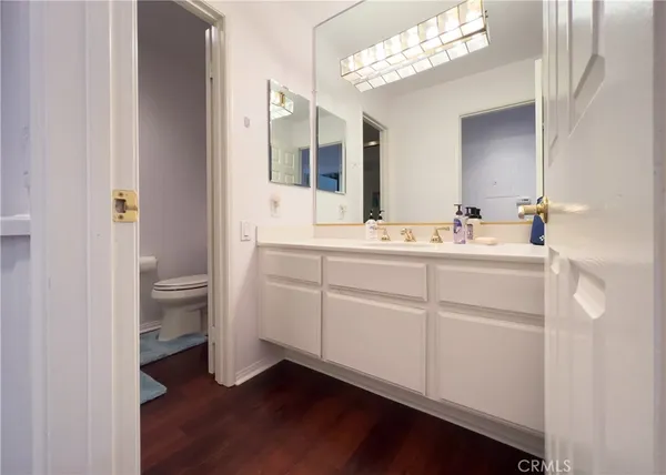 a bathroom with a double vanity sink mirror and toilet