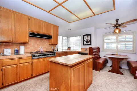 a large bedroom with a bed and wooden floor